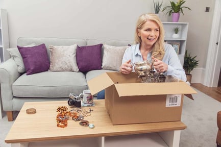 Woman packing box with antiques