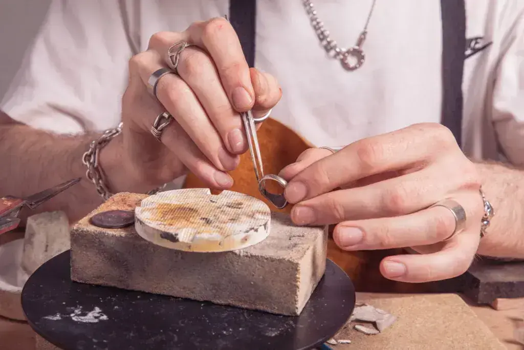 Male hands crafting a silver ring 