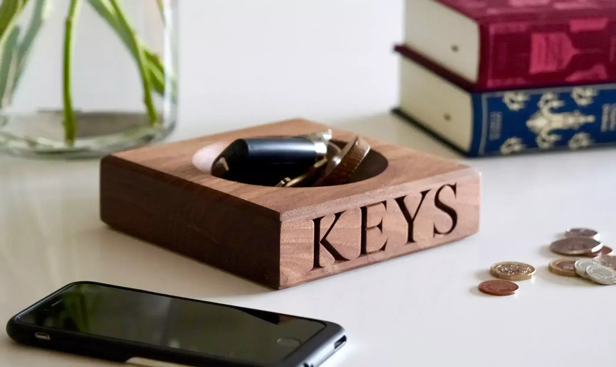 keys in a bowl that says 'keys' on table at home